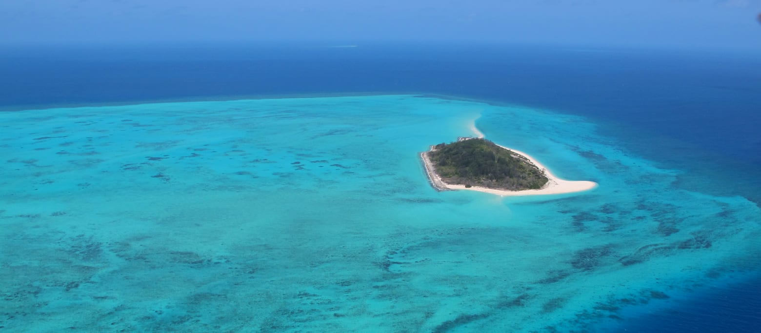 Aerial view of a reef island and surrounding sea country